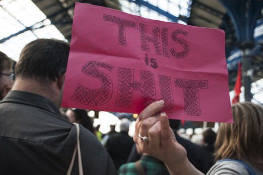 Brighton, East Sussex, 14th June 2016. Commuters hold a protest at Brighton Rail Station after suffering weeks of severe disruption due to staffing problems. Staff have been on strike and calling in sick due to disputes over Southerns proposed move to dri