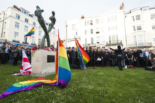 Brighton, East Sussex, 13th June 2016. LGBTQ communities gather for a procession and vigil at Brighton’s Aids Memorial Sculpture at New Steine in Kemptown, in memory of and in solidarity with the 49 people killed and others injured at Pulse gay bar in O