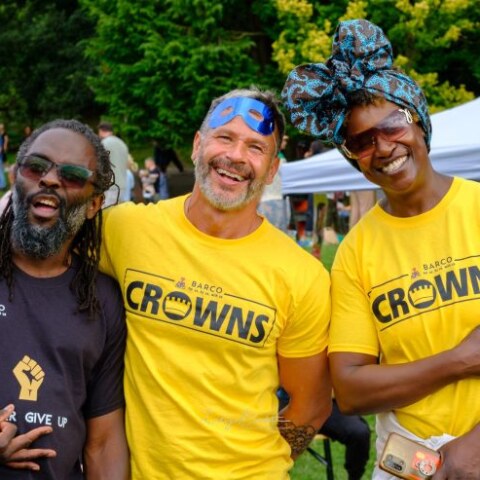 Three people smiling together